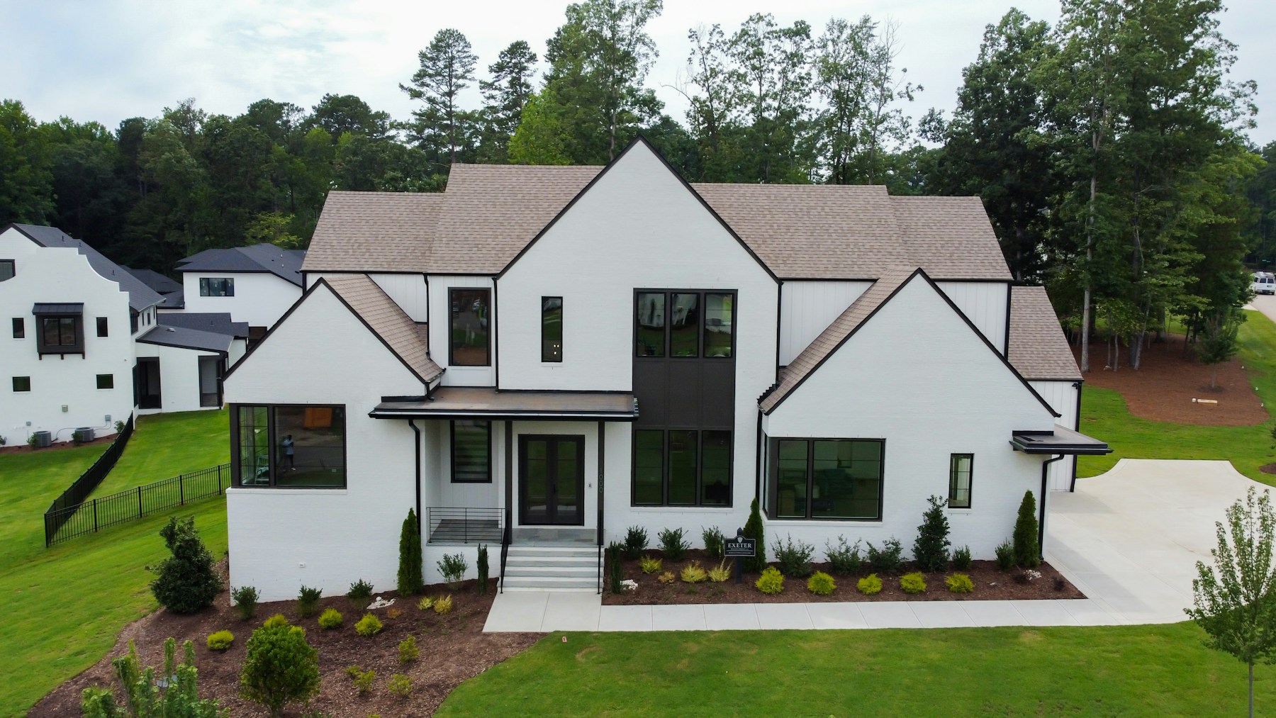 Large white house surrounded by landscaping