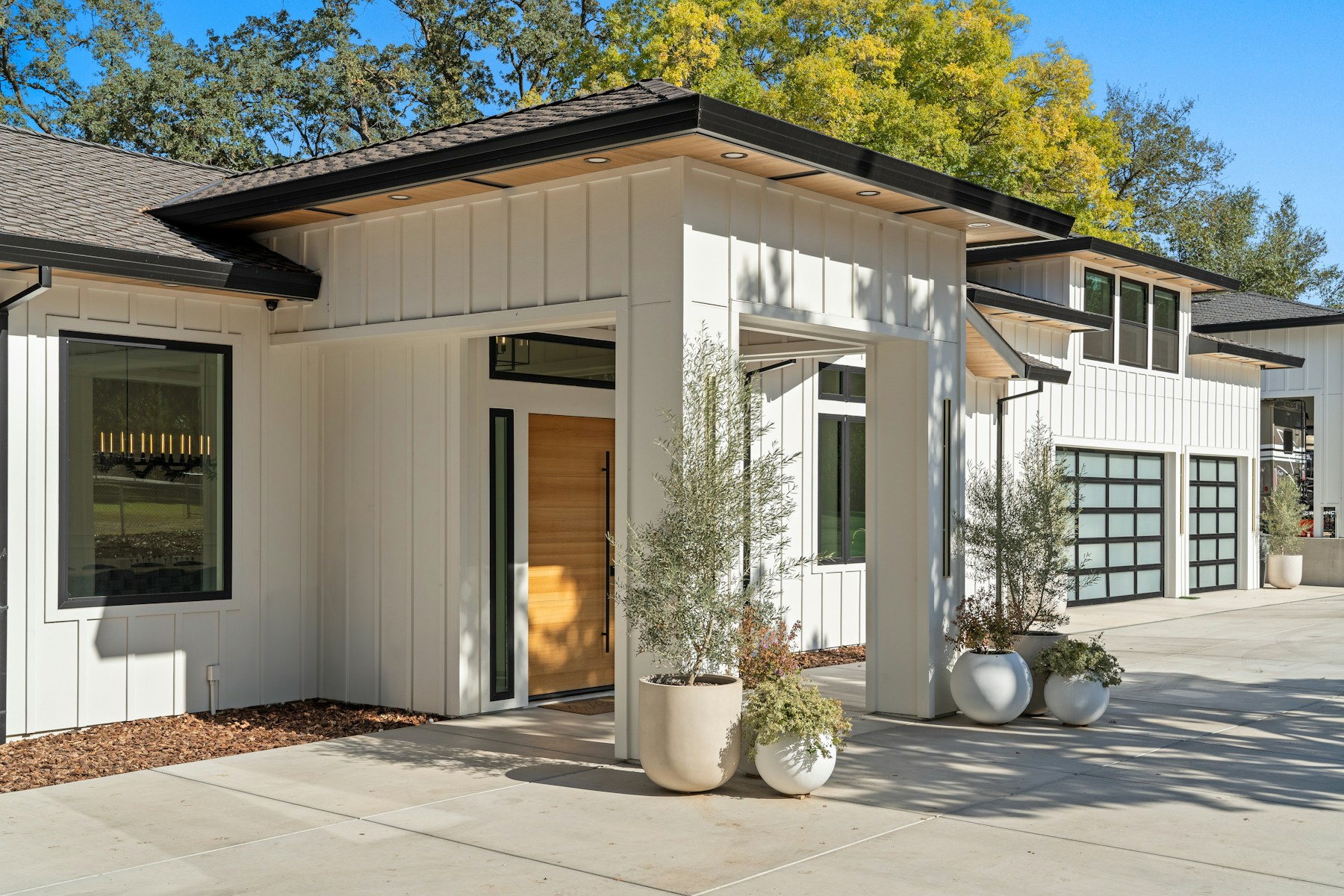 Modern farmhouse with a concrete driveway